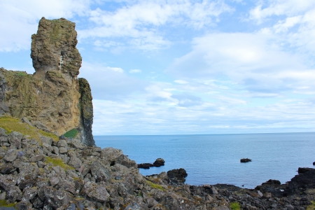 Gigantic lava rock watching over the polar North Sea on Snaefelsness peninsula, Icelandの写真素材