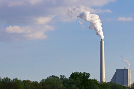 Huge factory chimney polluting the airの写真素材