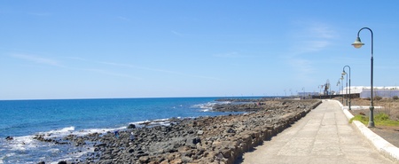 Beach promenade with typical street lamps on Lanzarote island, Spain