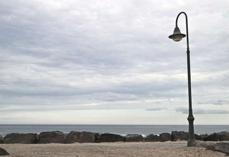 Las Cucharas beach walk with typical street lamps on Lanzarote island, Spainの写真素材