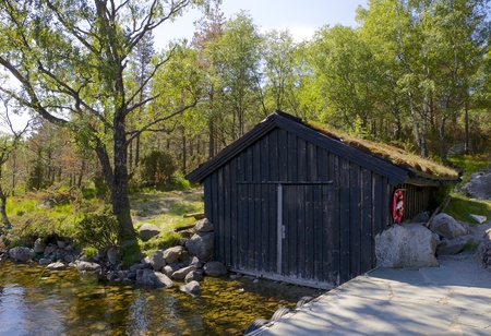 Fishing hut at the shore of Revsvatnet glacier lake, Norwayの写真素材
