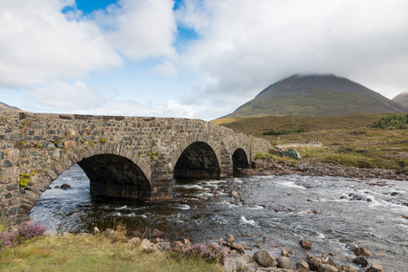 Old stone bridge in Scotland leading over a brook in the Highlandsの写真素材