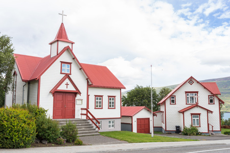 Small wooden church with red roof, typical for Iceland, in the city of Akureyriの写真素材