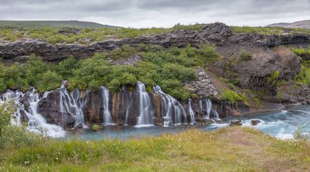 Long exposure shot of famous Hraunfossar waterfalls and cascade, a popular tourist destination in western Icelandの写真素材
