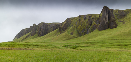 Mountain range and meadows in Kirkjubaejarklaustur, southern Icelandの写真素材