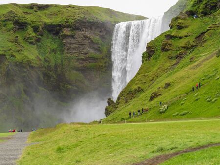 World famous Skogafoss, a majestic waterfall in southern Iceland, coming down over a cliff, fed by a glacierの写真素材