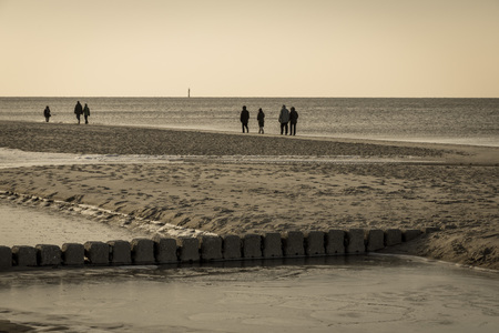 Old row of stones, built as a breakwater on the western beach of Sylt island, Germany, sepia effectの写真素材