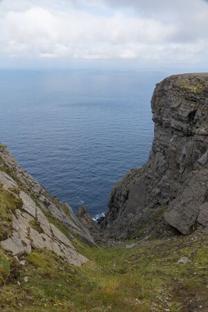 Rough rocky coastline at Europe's northernmost point, the arctic North Cape in Norwayの写真素材