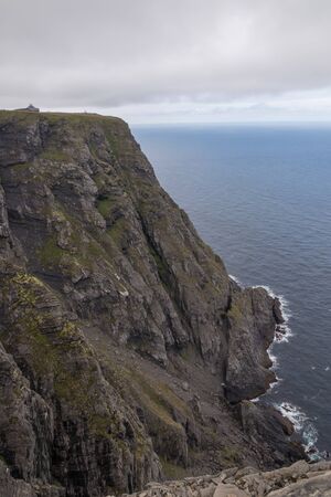 Rough rocky coastline at Europe's northernmost point, the arctic North Cape in Norwayの写真素材