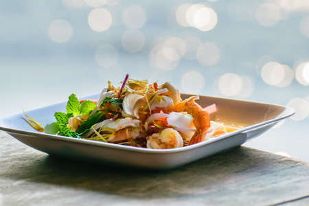 Thai foods,Spicy shrimp salad or pla koong,spicy shrimp salad in the dish on a wooden table.の写真素材