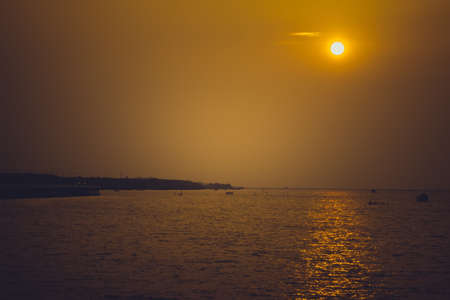 sky after sunset,Sunset,yellow and orange sky above it with sun golden . Amazing summer sunset viewの写真素材