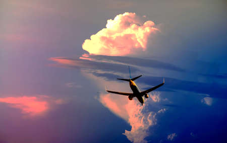 Silhouette passenger airplane flying to sky at night.の写真素材