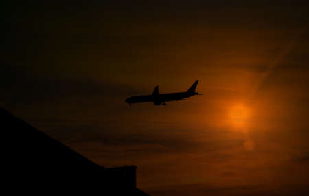 Silhouette passenger airplane flying to sky at night.の写真素材