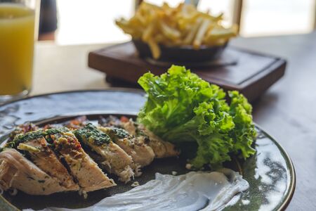 Chicken meat with sauce, french fries and orange juice
