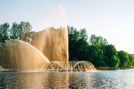 Vinnitsa, Ukraine. Dancing fountain on the river. Beautiful fountain on sunset background.の写真素材