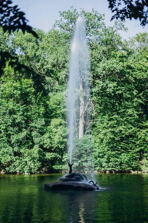 Sofia Park, Uman. Snake fountain among a large beautiful lake. High fountain among the lake in the national park. Splashes of a tall fountain on a summer dayの写真素材