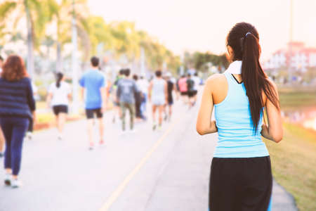 Teenage girls are jogging in the park.の写真素材