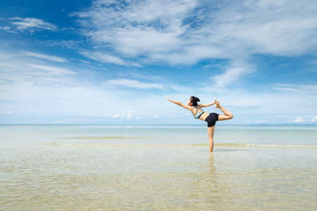 Young woman Yoga at the beach.の写真素材