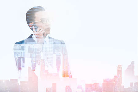 Male business man using telephone.