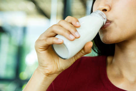 A young girl is drinking milk.の写真素材