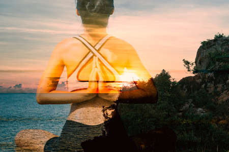 Women are doing yoga at sea.の写真素材
