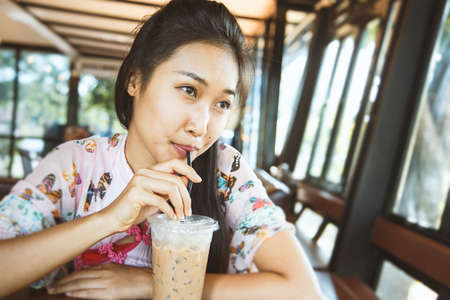 A young girl is drinking chocolate.の写真素材