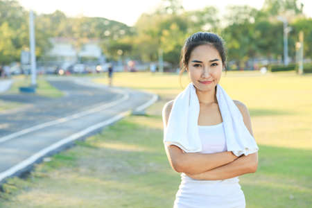 A women is  exercising and relaxing at the park.の写真素材