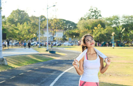 A women is  exercising and relaxing at the park.の写真素材