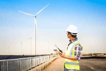 Engineers are investigating the wind turbine.の写真素材