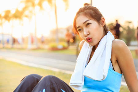 A women is  exercising and relaxing at the park.の写真素材