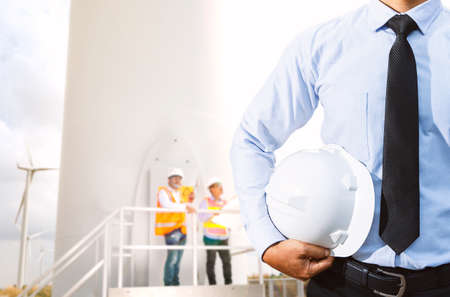 Engineers are investigating the wind turbine.の写真素材