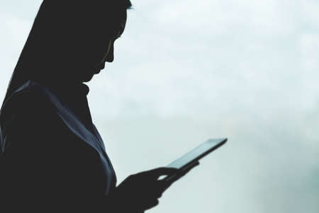 Business woman is usiug a tablet and working in the office. の写真素材