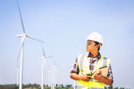 Engineers are investigating the wind turbine.の写真素材