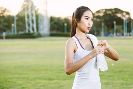A women is  exercising and relaxing at the park.の写真素材