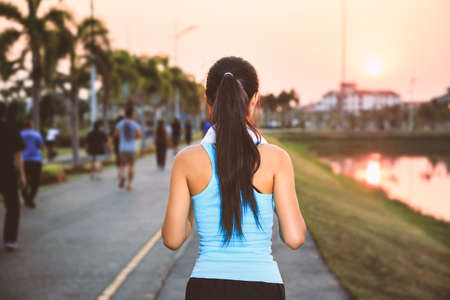 A women is  exercising and relaxing at the park.の写真素材