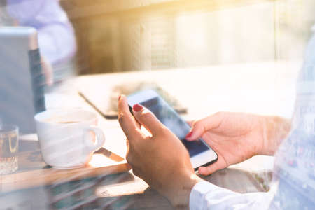 A business woman is working and using the phone.