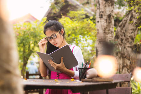 Asian women writing diary in notebook.の写真素材