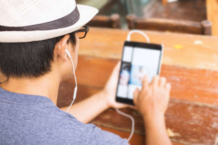 Asian men using a tablet in coffee shop.の写真素材