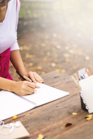 Asian women writing diary in notebook.の写真素材