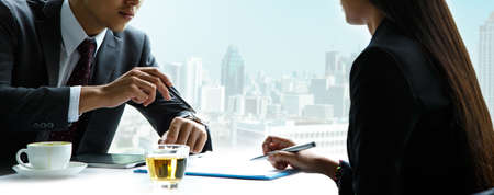 Businessmen and women businessmen are coming late.の写真素材