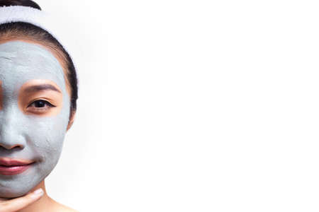 A woman is marking a face isolated on white