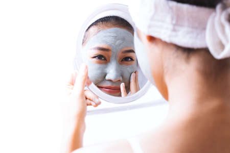 A woman is marking a face.