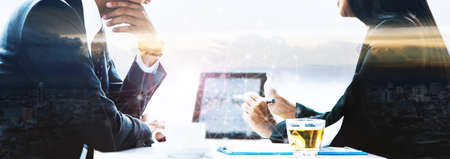 Male businessman and businesswoman using a tablet and icon.