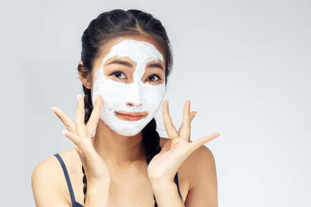 A woman is marking a face with mud.の写真素材