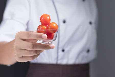 The chefs are picking fresh tomatoes to cookの写真素材