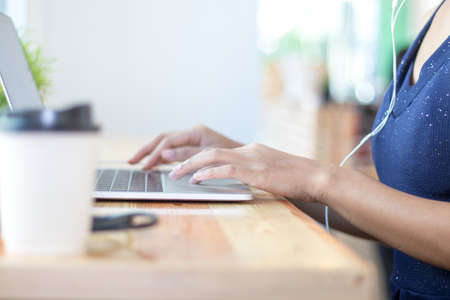 Women are using laptop and earpiece.