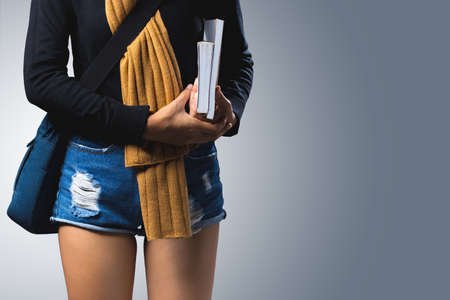 Female student are carrying bags and carrying books.の写真素材