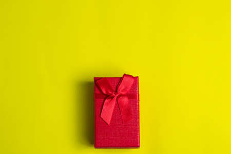 Red gift box on yellow background.
