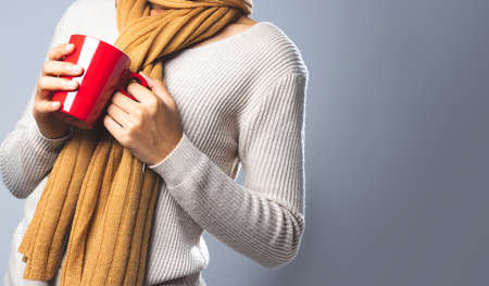 Woman drinking hot coffee in winter.