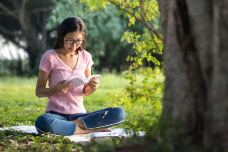 Woman reading a book in the garden.